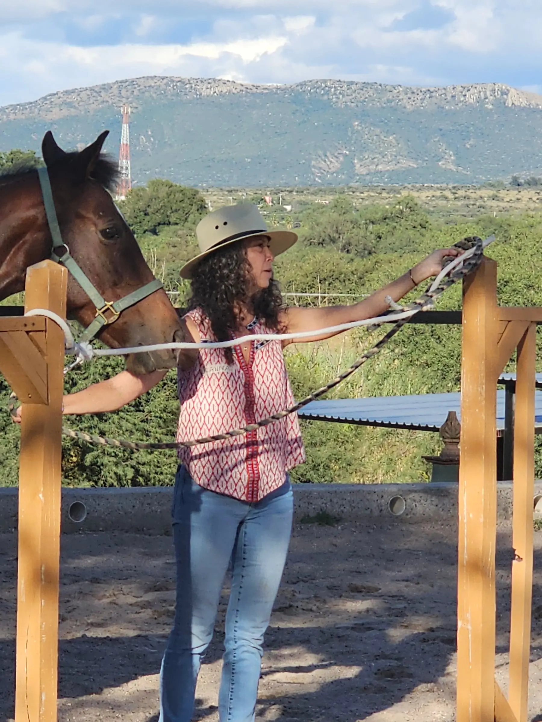 Alanna Levenson with one of the herd, the sierra behind them