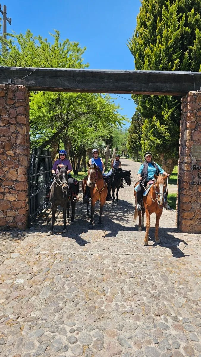 Riders coming home through the ranch gate