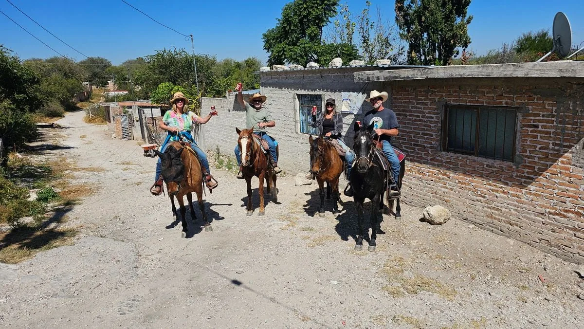 Riders passing through the village of San Miguelito