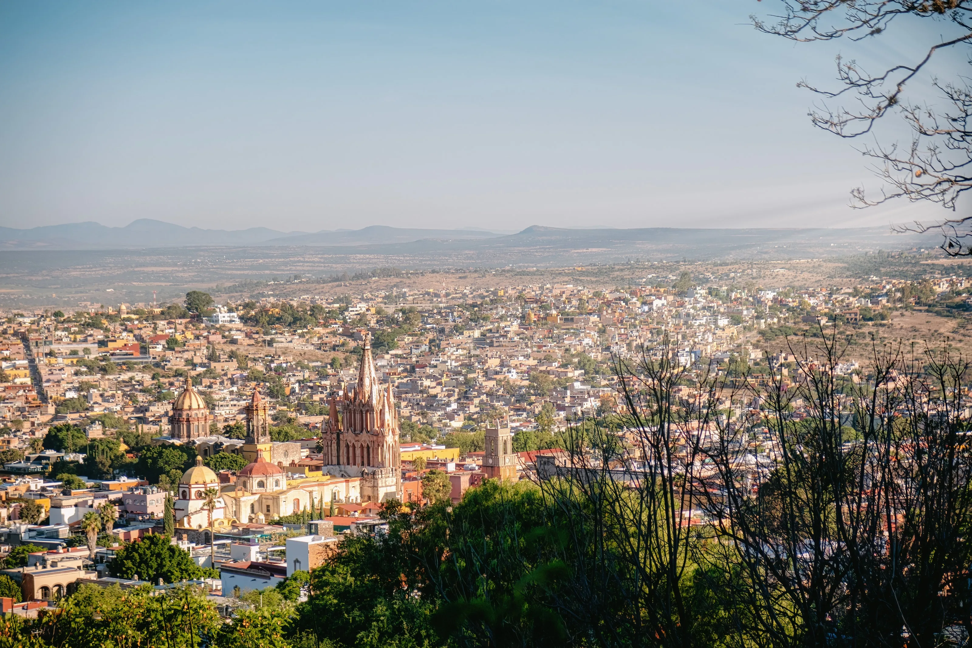 San Miguel de Allende and its parish church seen from the hills, with the high desert countryside beyond